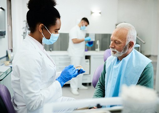 A dentist checking her patient’s dentures